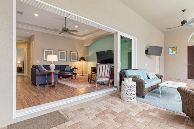 living room with ceiling fan, light hardwood / wood-style floors, and ornamental molding