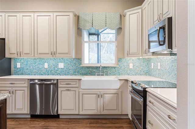 kitchen featuring decorative backsplash, dark hardwood / wood-style flooring, sink, and stainless steel appliances