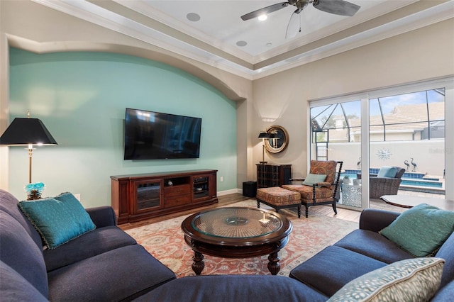 living room with crown molding, light hardwood / wood-style flooring, and ceiling fan