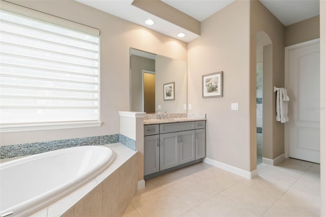 bathroom with shower with separate bathtub, vanity, and tile patterned floors