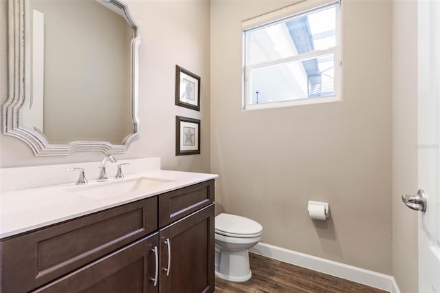 bathroom featuring hardwood / wood-style flooring, vanity, and toilet