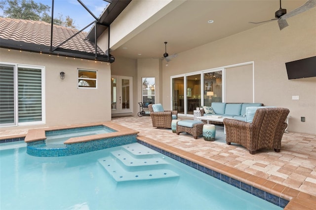 view of pool featuring an in ground hot tub, an outdoor hangout area, ceiling fan, glass enclosure, and a patio