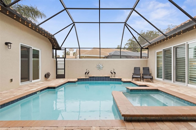 view of swimming pool featuring glass enclosure, an in ground hot tub, and a patio