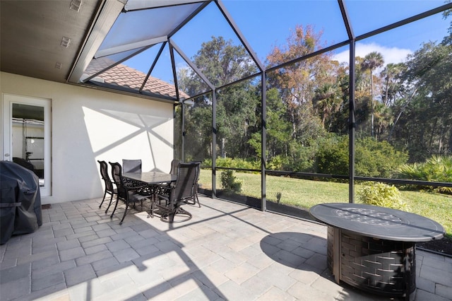 sunroom featuring plenty of natural light and a pool