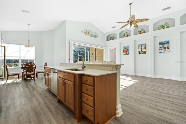 kitchen featuring dark hardwood / wood-style floors, a center island with sink, ceiling fan, and sink