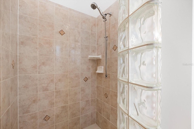 bathroom with a tile shower