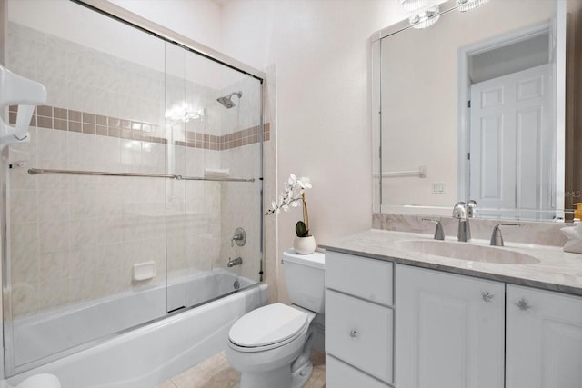 full bathroom featuring shower / bath combination with glass door, vanity, toilet, and tile patterned flooring