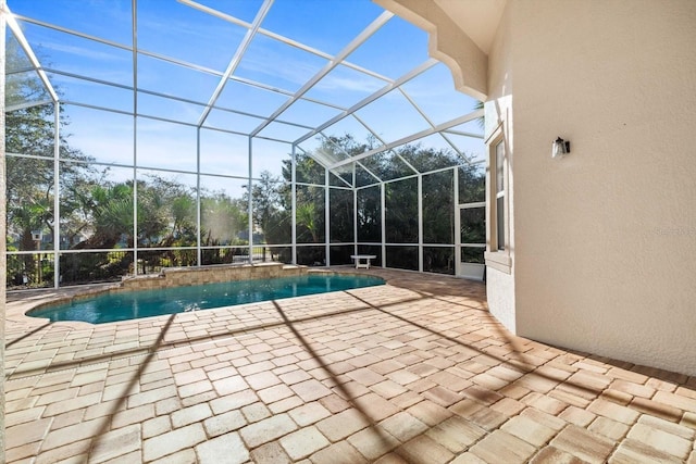 view of swimming pool with pool water feature, a lanai, and a patio