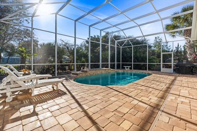 view of pool featuring a lanai, area for grilling, and a patio area