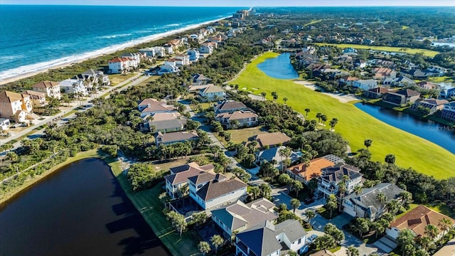 drone / aerial view featuring a water view and a view of the beach