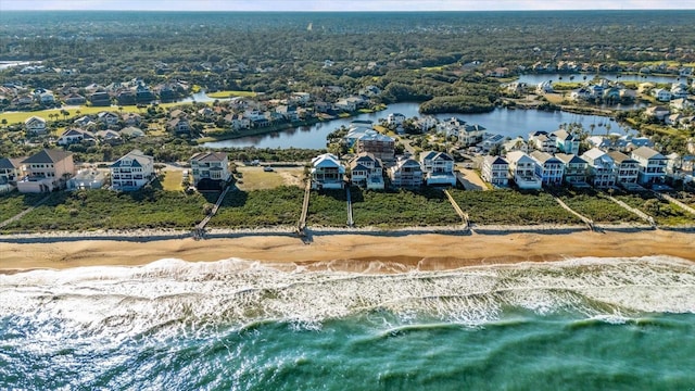 birds eye view of property featuring a water view and a beach view