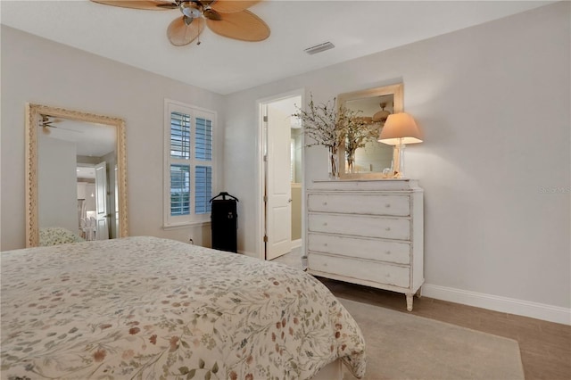 bedroom with ceiling fan, hardwood / wood-style floors, and ensuite bathroom