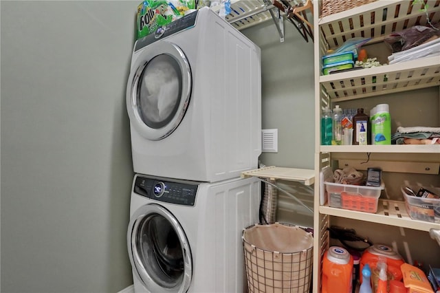 laundry area with stacked washer / drying machine