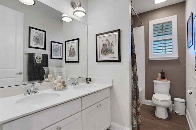 bathroom featuring walk in shower, hardwood / wood-style floors, vanity, and toilet