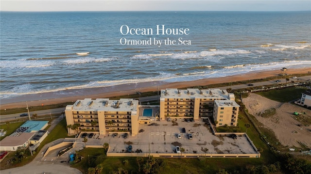 birds eye view of property featuring a water view and a view of the beach