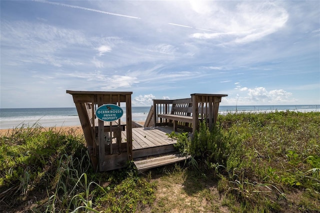 view of home's community with a water view and a view of the beach