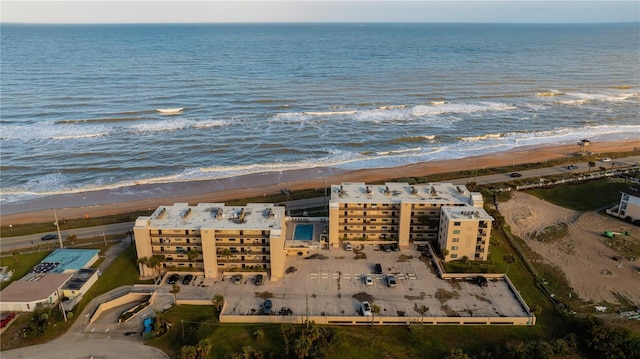 drone / aerial view with a water view and a view of the beach