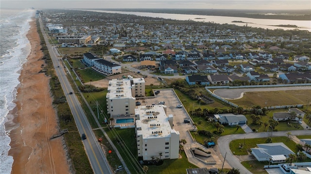 bird's eye view featuring a water view and a view of the beach