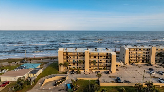 drone / aerial view featuring a beach view and a water view