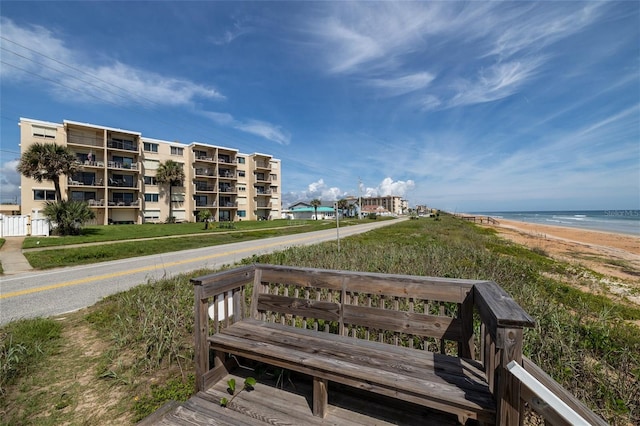 surrounding community featuring a water view and a view of the beach