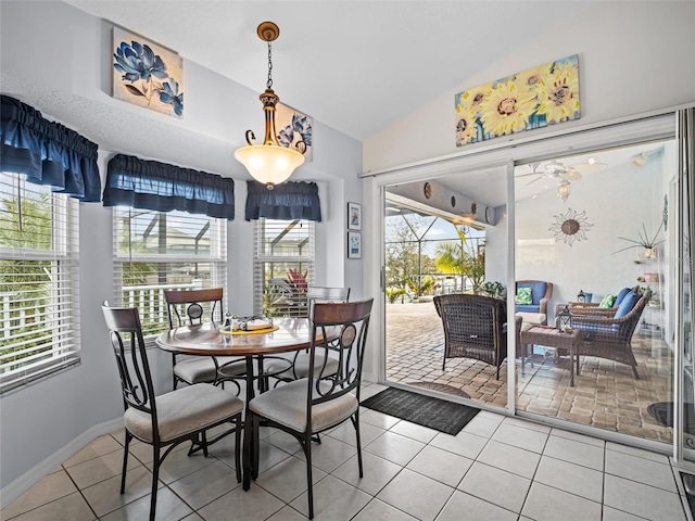 dining room with tile patterned flooring and lofted ceiling