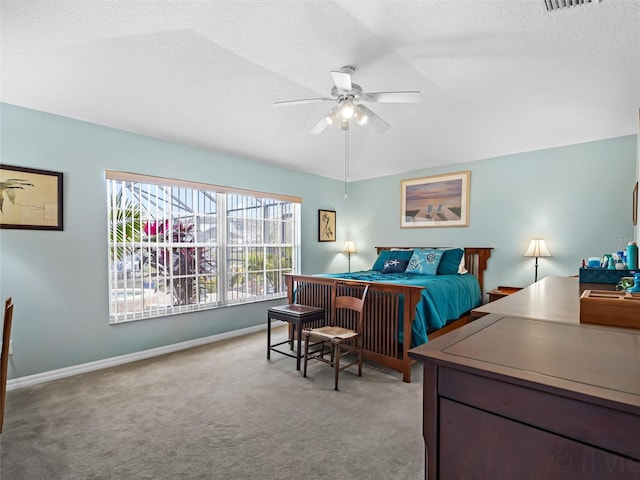 carpeted bedroom featuring a textured ceiling, ceiling fan, and vaulted ceiling