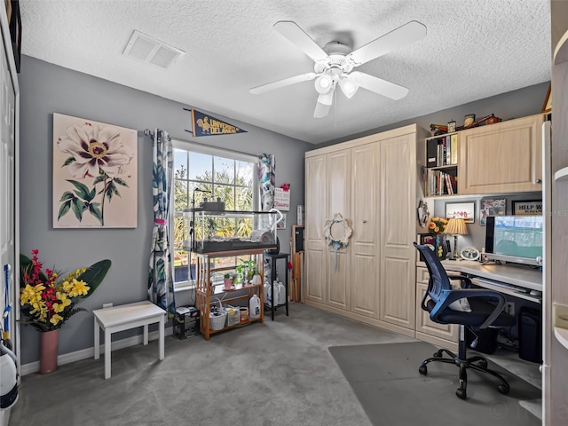 office featuring ceiling fan, carpet, and a textured ceiling