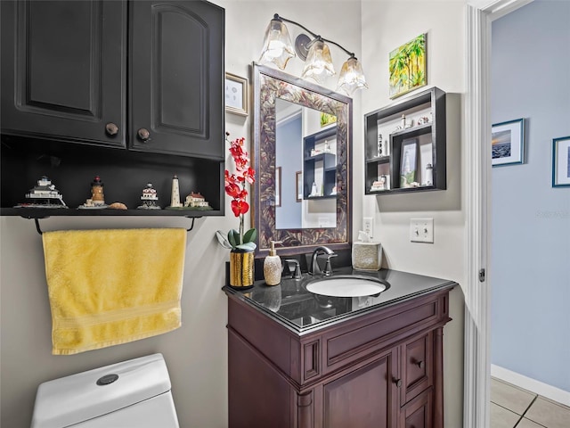 bathroom featuring tile patterned flooring, vanity, and toilet