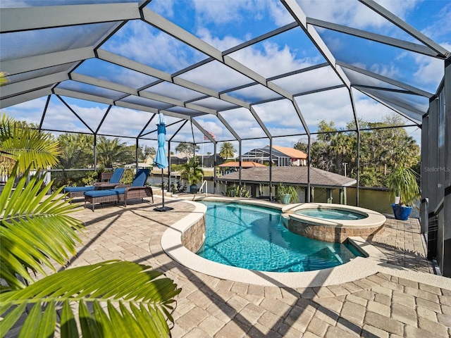 view of pool featuring glass enclosure, a patio area, and an in ground hot tub