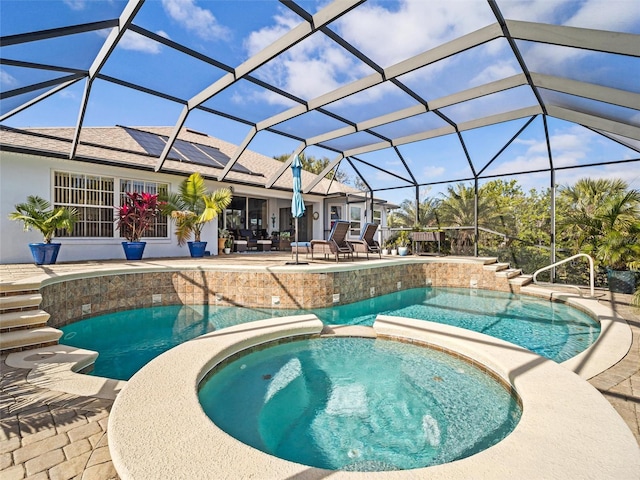 view of swimming pool featuring glass enclosure, a patio area, and an in ground hot tub