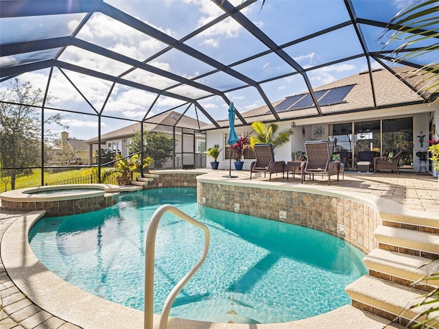 view of pool with a lanai, an in ground hot tub, and a patio