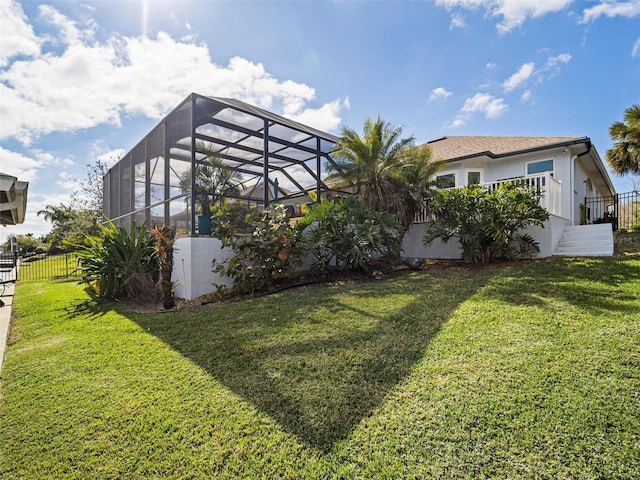 view of yard with glass enclosure