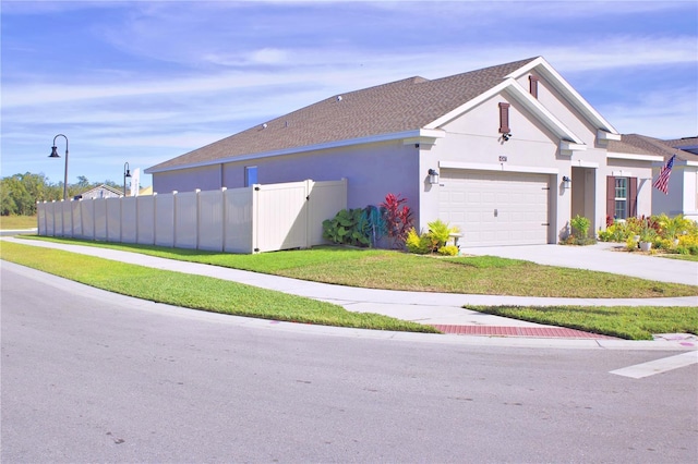 view of property exterior featuring a lawn and a garage