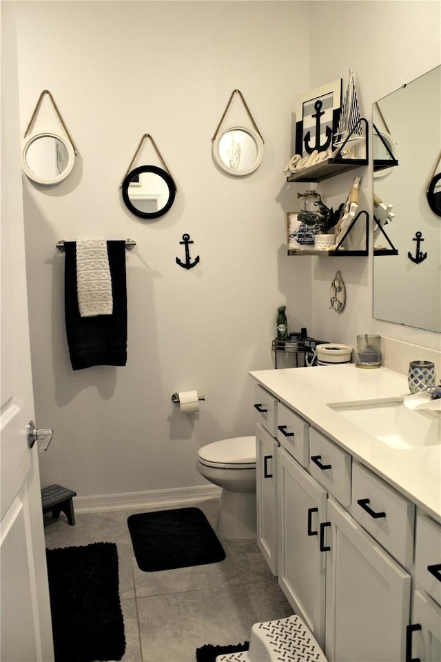 bathroom featuring tile patterned floors, vanity, and toilet