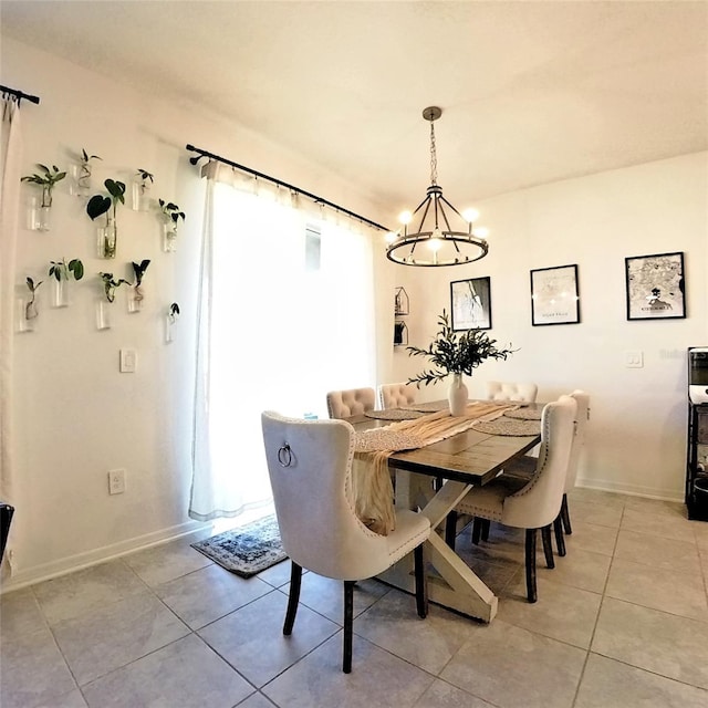 dining room featuring a chandelier and light tile patterned floors