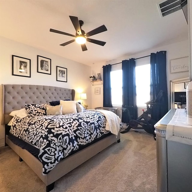 bedroom with ceiling fan and light carpet