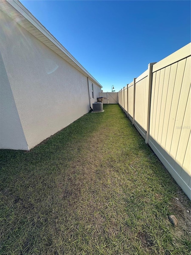 view of yard featuring central air condition unit