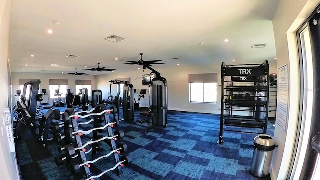 workout area featuring dark colored carpet, a wealth of natural light, and ceiling fan