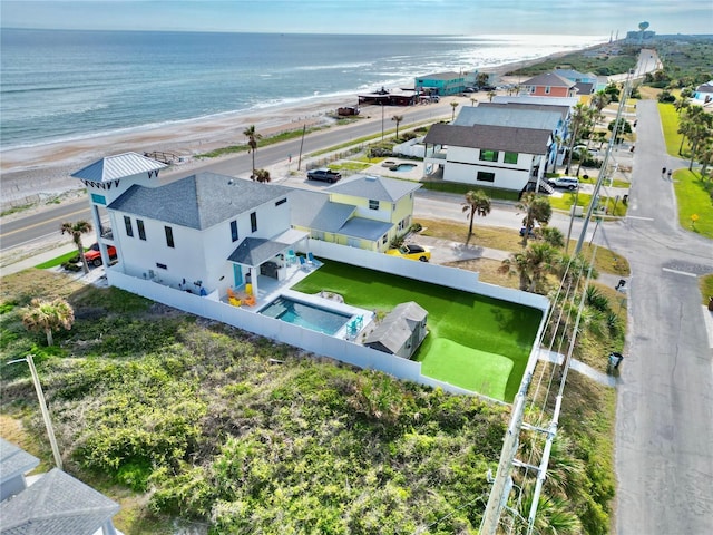 drone / aerial view featuring a water view and a beach view