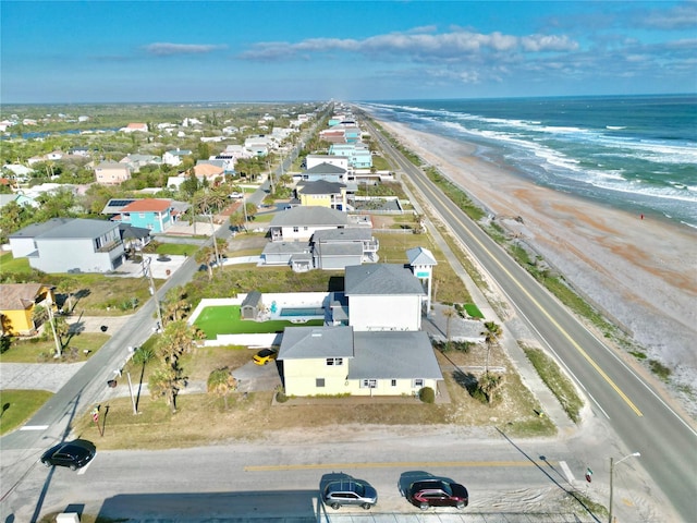 aerial view with a water view and a view of the beach