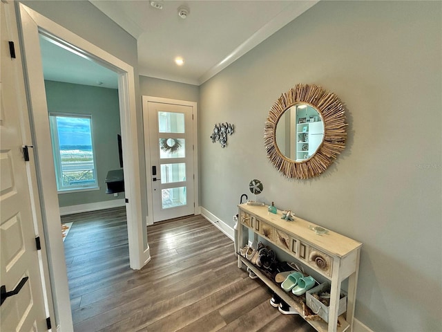 entryway with dark wood-type flooring and ornamental molding