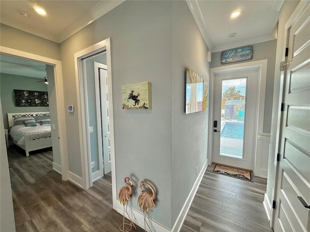 entryway with dark hardwood / wood-style flooring and ornamental molding