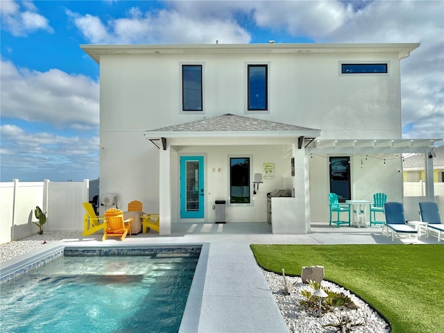 back of house with a patio area and a fenced in pool