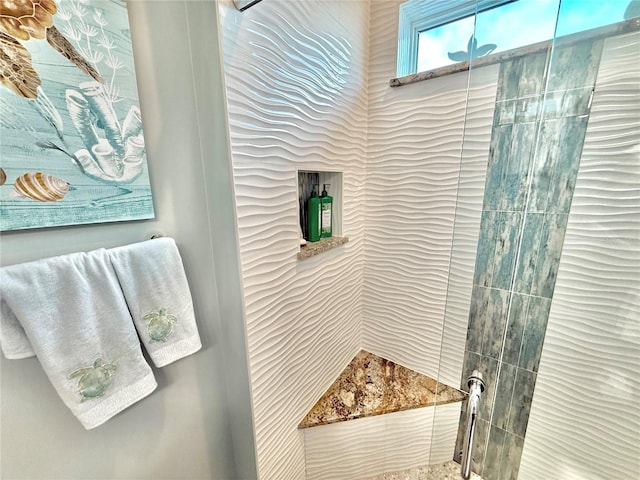 bathroom with a tile shower