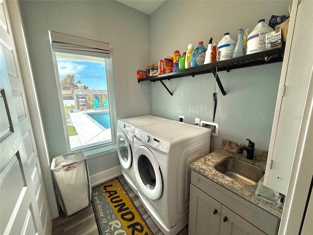 laundry room with washer and dryer, cabinets, sink, and a wealth of natural light