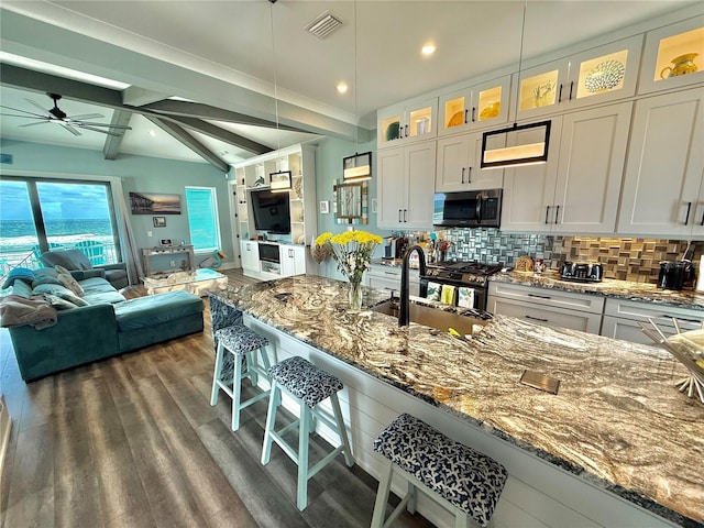 kitchen featuring white cabinets, ceiling fan, sink, and hanging light fixtures