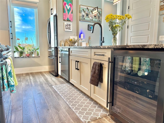 interior space featuring vanity, beverage cooler, and hardwood / wood-style flooring