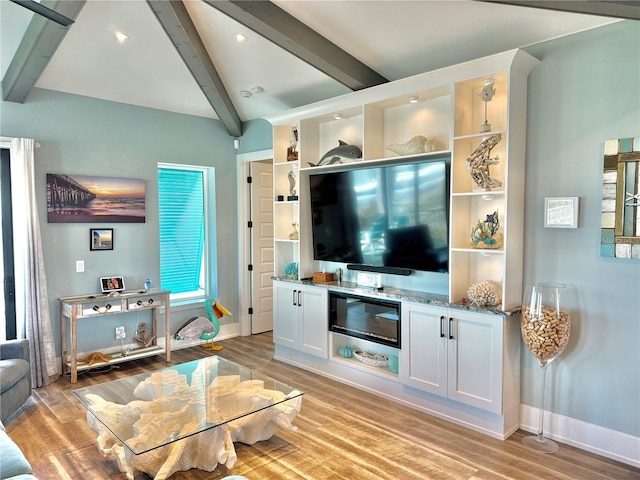 living room featuring beam ceiling and light wood-type flooring