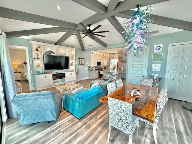 living room with vaulted ceiling with beams, light hardwood / wood-style floors, and ceiling fan