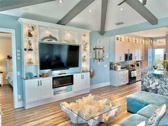 living room with beam ceiling and light hardwood / wood-style flooring